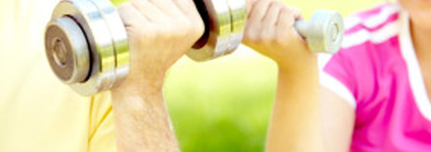Two seniors holding up dumbbells