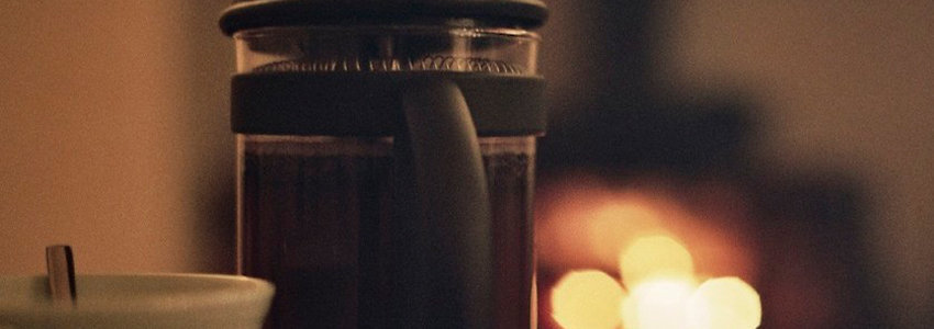 Modern coffee maker in a dimly lit room