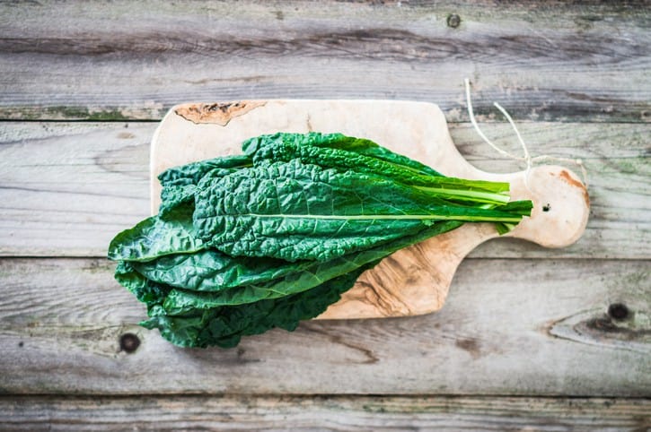 Kale on wooden background